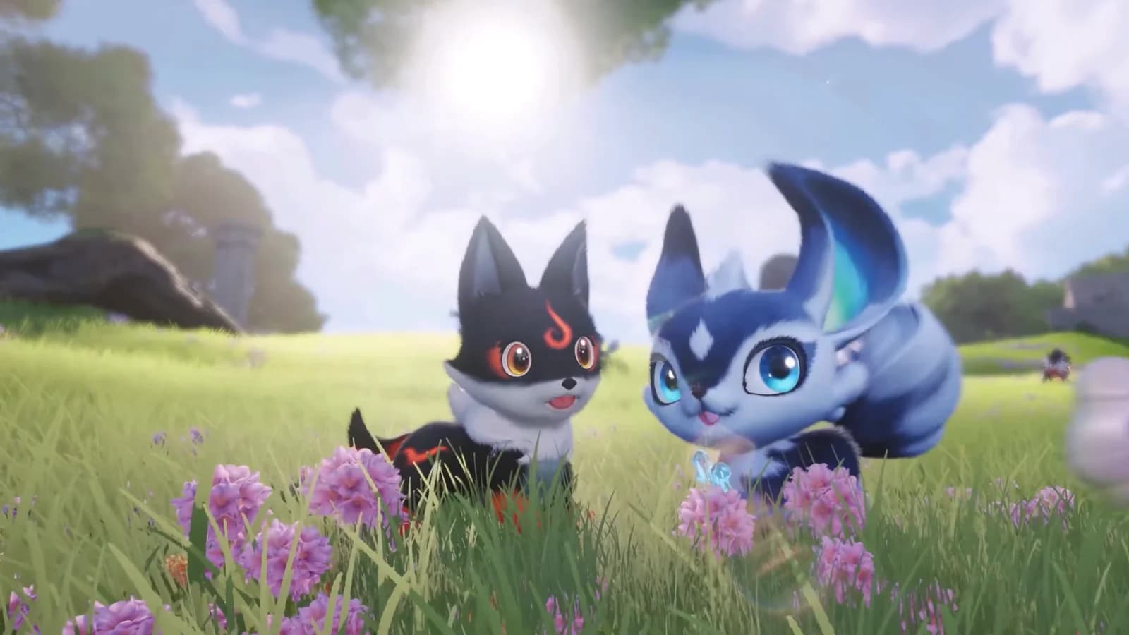 A black Aniimo with burning orange eye markings sits in a sunlit flower meadow beside a blue and white one