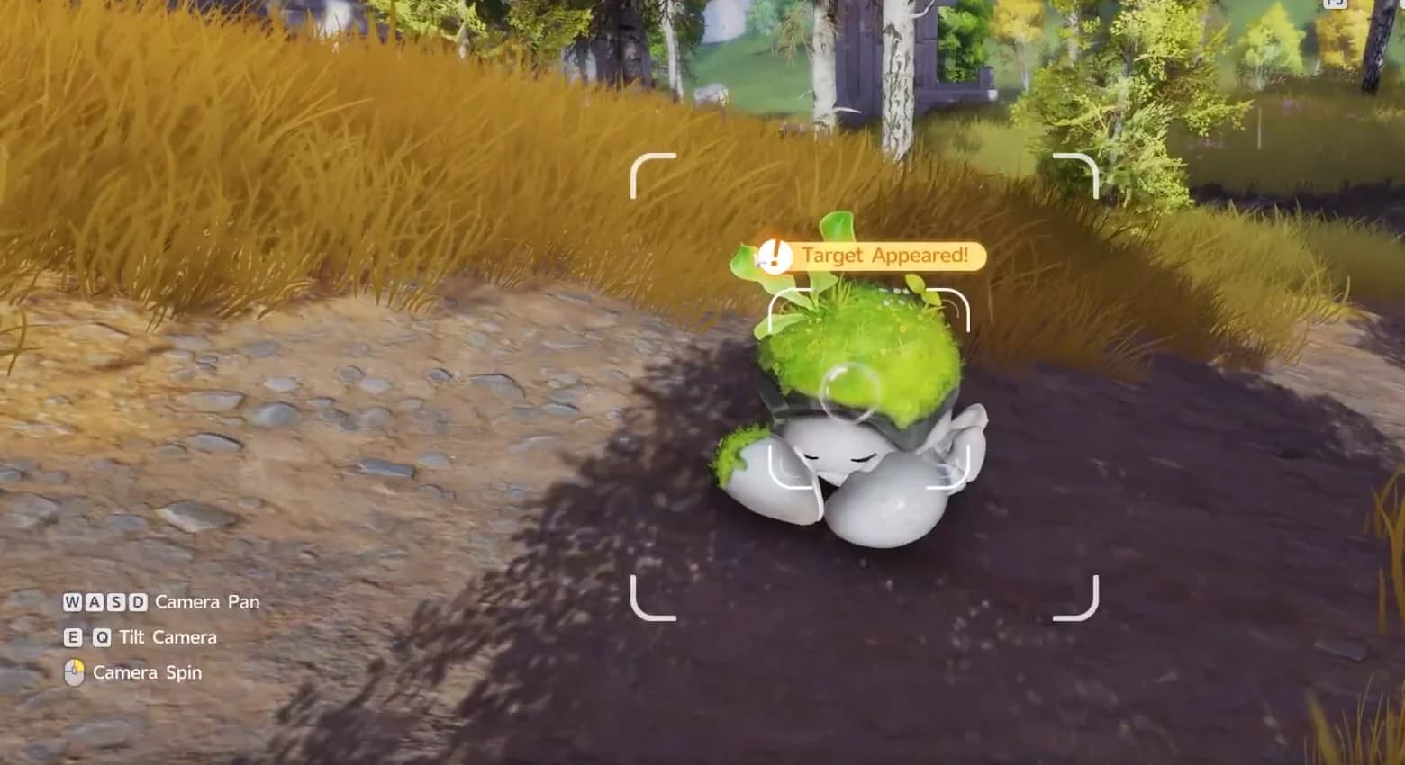 Camera mode framing a wild Budclaw in tall grass with a Target Appeared banner above it