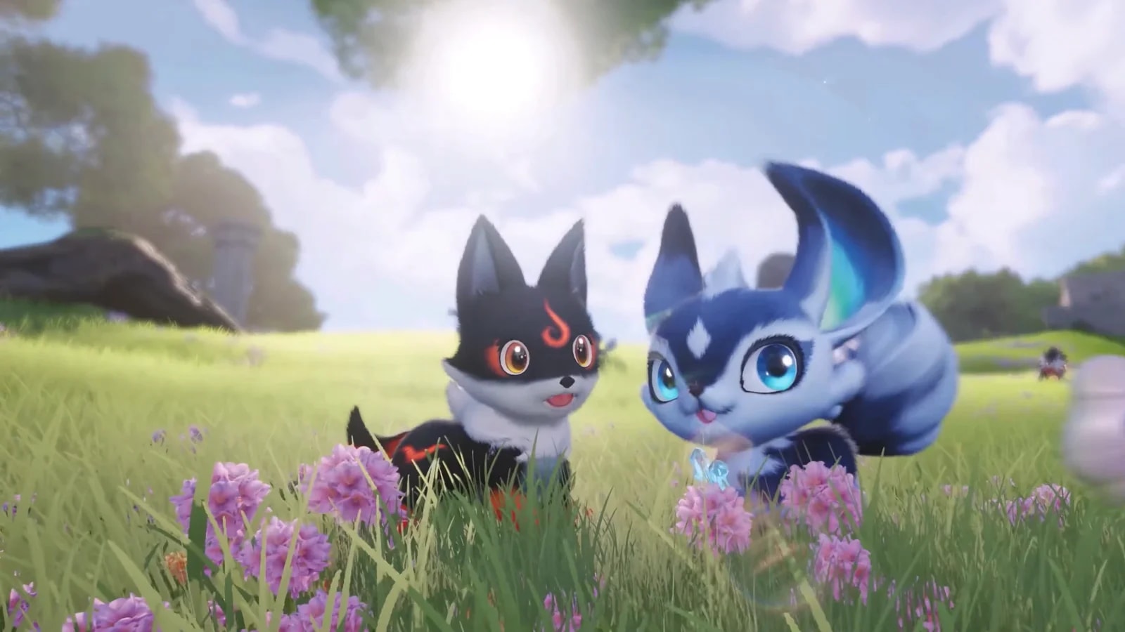 A black Aniimo with burning orange eye markings sits in a sunlit flower meadow beside a blue and white one