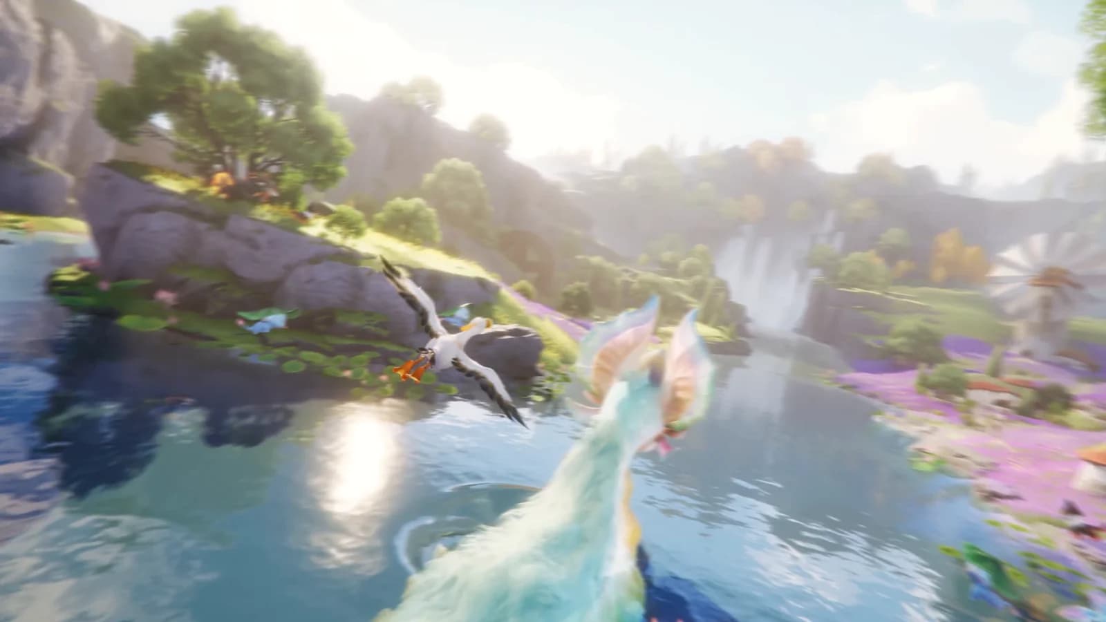 A white long-winged Aniimo glides low over a sunlit lake past waterfalls and a lavender shore
